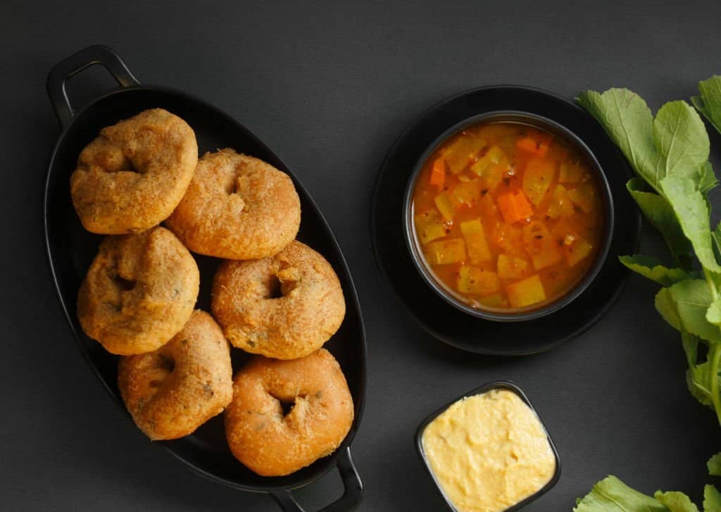 Medu Vada, a popular South Indian food served with Sambar ,Green coconut chutney ,Vada / Medu vadai with sambar - Popular South Indian snack